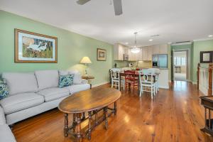 a living room with a couch and a table at 545 Beachview Dr in Saint Simons