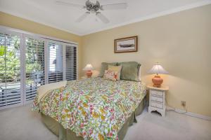 a bedroom with a bed and a window at 545 Beachview Dr in Saint Simons