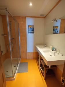 Un baño con dos lavabos y una ducha. en Los Molinos - Atico en Montaña de Asturias, en Felechosa