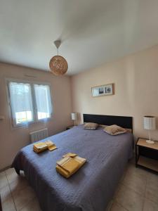 een slaapkamer met een bed met twee handdoeken erop bij Chez Carisa in Puilboreau