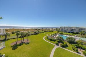 an aerial view of a resort with a pool and palm trees at St. Simons Grand #325 in East End