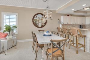 a kitchen and dining room with a table and chairs at St. Simons Grand #325 in East End