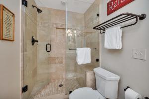 a bathroom with a shower and a toilet at St. Simons Grand #325 in East End +29 photos