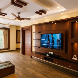 ein Wohnzimmer mit einem großen Flachbildfernseher in der Unterkunft Vensa corporate Inn in Bhubaneshwar