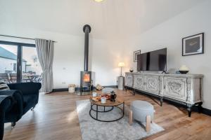 a living room with a couch and a fire place at 5 Bed in Galston oc-s33451 in Galston