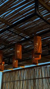 a row of lights hanging from a ceiling at FYAFY Bidiyah Bedouin Camp in Bidiyah +50 photos