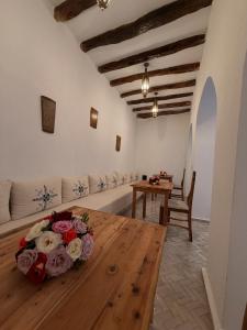 a living room with a table with flowers on it at Riad le myrath in Essaouira