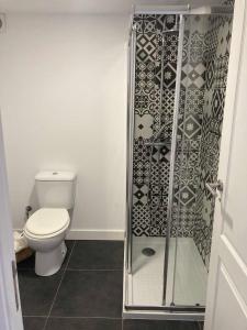 a bathroom with a toilet and a glass shower at Casa Água  +15 photos