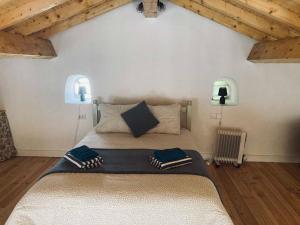 a bedroom with a large bed in a room with wooden ceilings at Casa Água 