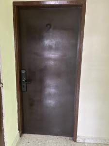 a metal door with the number two on it at Renta de habitación equipada para ejecutivos in Saltillo