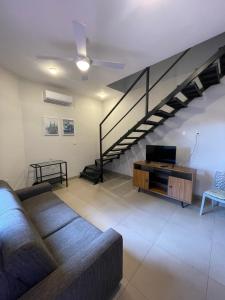 a living room with a couch and a staircase at CDE duplex Rent II - 2 Dormitorios - 4 camas in Ciudad del Este