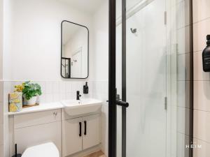 a bathroom with a sink and a shower at Ember at The Heim Residences in Manchester
