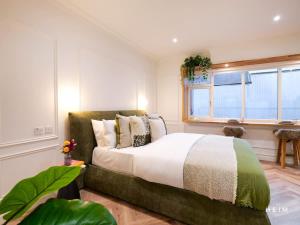 a bedroom with a large bed and a window at Ember at The Heim Residences in Manchester
