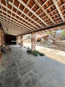 un patio esterno con soffitto in legno e piante di Chácara passárgada a Gravatá