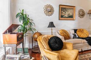 a living room with a couch and a chair at Miss Murphy's High Street Inn in Galena +14 photos