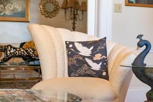 aige chair with a black and white pillow on it at Miss Murphy's High Street Inn in Galena