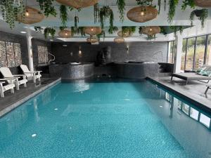 a large swimming pool in a hotel room at Beech Hill Hotel & Spa in Windermere