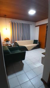 a living room with a bed and a couch at Natureza e sossego in Volta Redonda