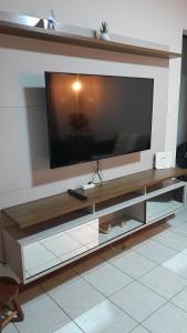 a large entertainment center with a large flat screen tv at Natureza e sossego in Volta Redonda