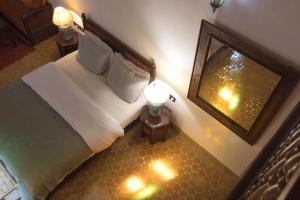 an overhead view of a bedroom with a bed and a mirror at Riad Ruh Fes in Fez