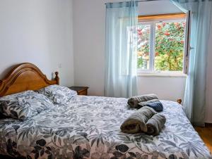 ein Bett mit zwei Handtüchern und einem Fenster in der Unterkunft Onda Atlântica - Atlantic Wave Peniche in Peniche + 61 Fotos