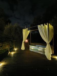 a couple of white curtains are lit up at night at Le Querce Dell'Etna B&B in Ragalna +33 photos