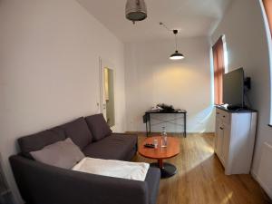 a living room with a couch and a table at Gästehaus urucu in Bornheim +6 photos