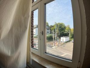a window with a view of a street at Gästehaus urucu in Bornheim