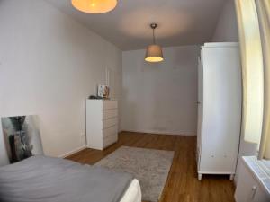 a bedroom with a bed and a white dresser at Gästehaus urucu in Bornheim