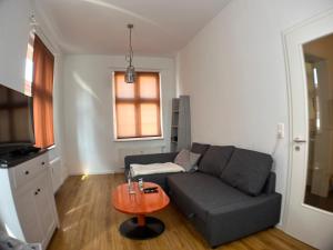 a living room with a couch and a table at Gästehaus urucu in Bornheim