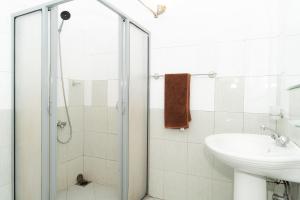 バンダーラウェラにあるHotel Lion Innのシャワーと洗面台を備えた白いバスルーム +21枚の写真