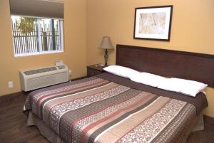 a bedroom with a large bed and a window at Commodore Resort in Put-in-Bay