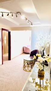 a living room with a glass table and a couch at Sea View Holiday Home with Parking in Ajman 