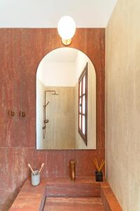 a bathroom with a sink and a mirror at Merry del Mare in Meyisti