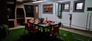 a table and chairs in a room with green grass at 56 Archer Crescent Mainhouse in Durban