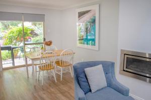 a living room with a blue couch and a table at Balneaire 13 in Albany