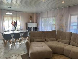 a living room with a couch and a table at Ferienwohnung Nidderau Komfort in Nidderau
