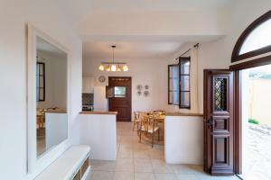 a kitchen and living room with a dining room at Merry del Mare in Meyisti +22 photos