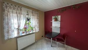 a room with a window and a table and chairs at Ferienwohnung Nidderau Komfort in Nidderau
