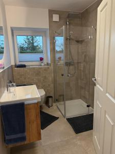 a bathroom with a shower and a sink at Fewo Voßbarg ünnen in Rastede +6 photos