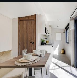 een eetkamer met een tafel met borden en glazen bij Tinny House in Offemont