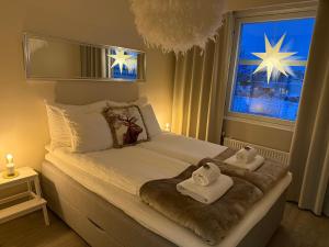 a bedroom with a bed with towels on it at Your Lapland Adventure Base in Rovaniemi