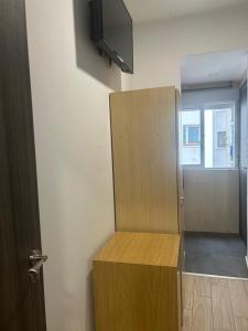 a room with a cabinet and a tv and a door at Pensión La Ferroviaria - No Fumadores - Sin Ascensor in Zaragoza