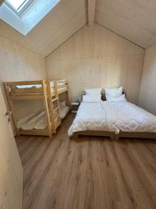 a bedroom with a bed and two bunk beds at Silenen Chalet I Andermatt I Ski I Berg I Familie in Silenen