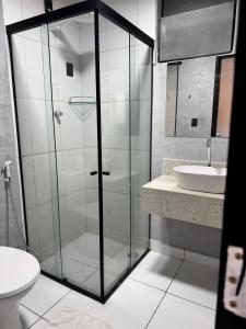 a bathroom with a glass shower and a sink at City Studios Apartamentos Novos em Natal in Natal +40 photos