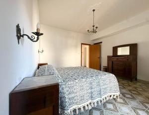 a bedroom with a bed and a dresser at Casa Felice 1910 in Introdacqua