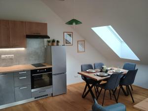 a kitchen with a table and chairs in a room at Apartmán Vail in Svoboda nad Úpou