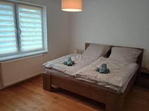 a bedroom with a bed with two pillows on it at Apartmán Vail in Svoboda nad Úpou