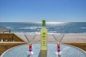 a bottle of wine sitting on a table with two glasses at Shore Bet in Surf City