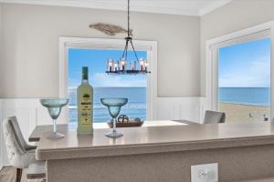 a kitchen with a table with a bottle of wine and glasses at Shore Bet in Surf City